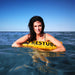 Woman floating on the water leaning over rest tube floating buoy