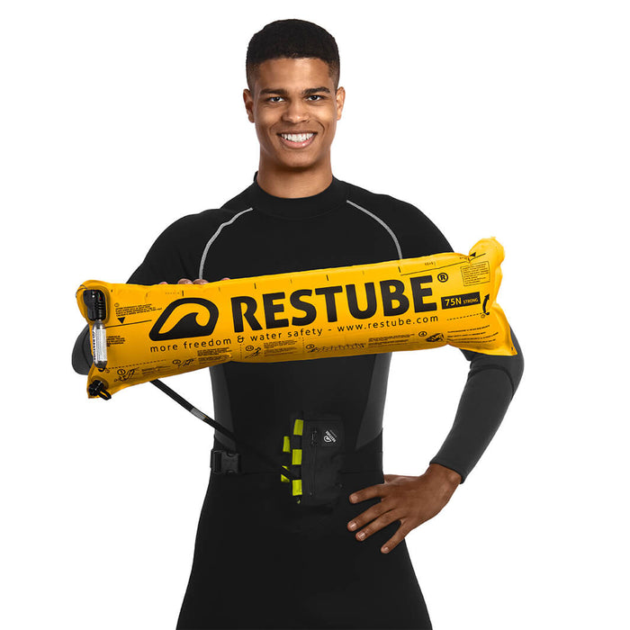 Swimmer in wetsuit presents inflated restube extreme 