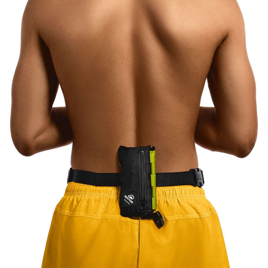 Man in yellow swim shorts wears Restube active in black color around waist